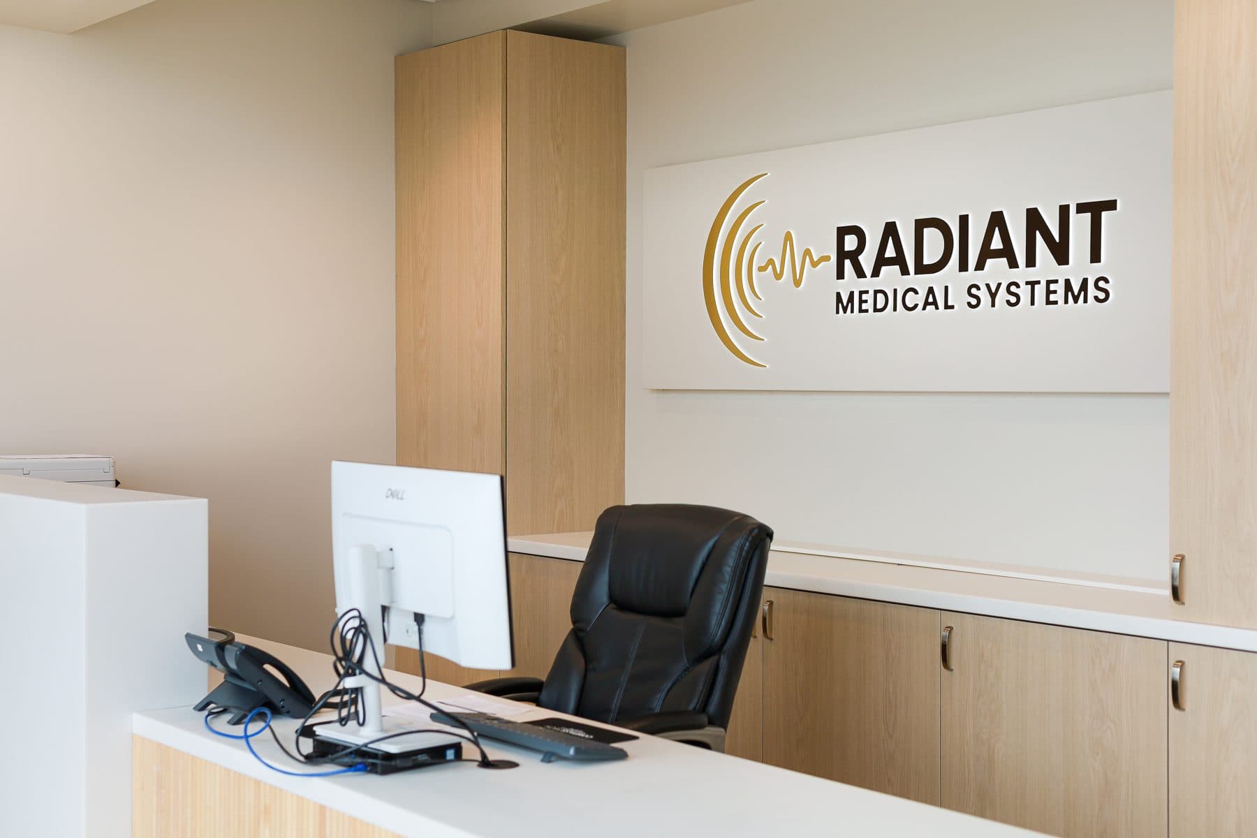 The reception desk, with the Radiant Medical Systems logo on the wall behind it