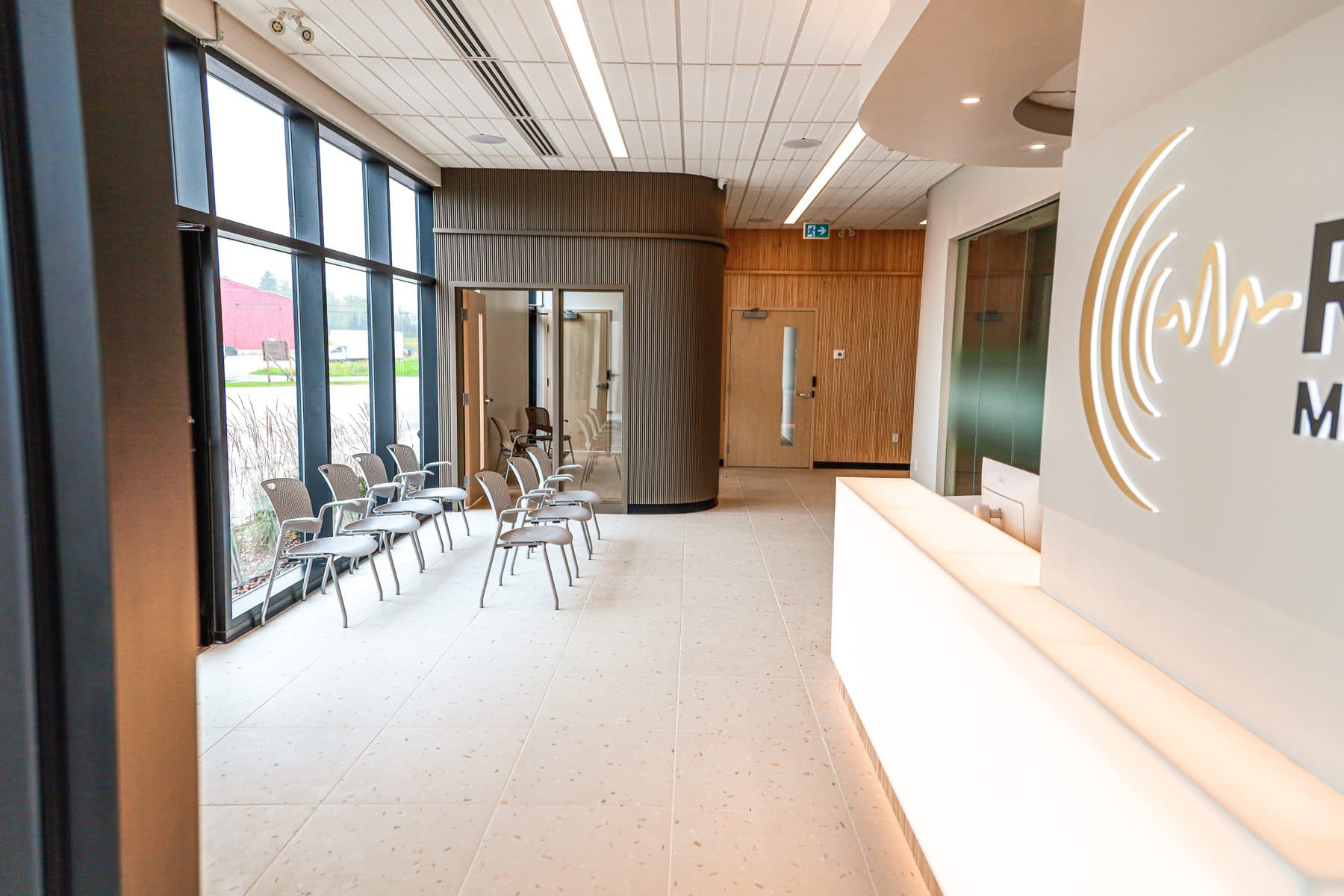 The waiting area, with wood-panelled walls and floor-to-ceiling windows